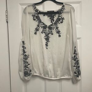 White House, Black market white sheer blouse was black embroidered flowers.